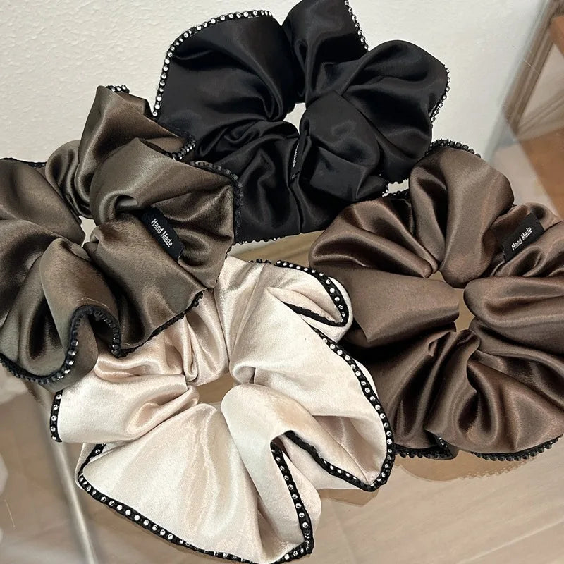 Stylish Hair Accessories: A variety of satin elastic hair ties, rhinestone headbands.